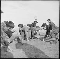 FootballRelocation Center, Amache, Colorado. Grade school boys playing touch football during the re . . . - NARA - 539109